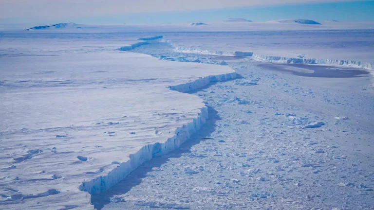 Aerial photo of a massive rift at Pine Island Glacier where iceberg B-46 calved, illustrating Antarctic ice loss processes monitored by satellite and flight missions.