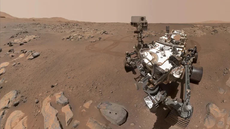 Selfie of NASA’s Perseverance rover beside the rock “Rochette” with two visible drill holes from core sampling on the Martian surface.