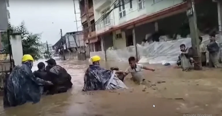 Rescue operative helping out citizens who have been stranded in the flooded streets of Nepal.